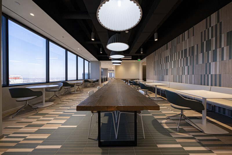 A long wooden table in the center of an office setting