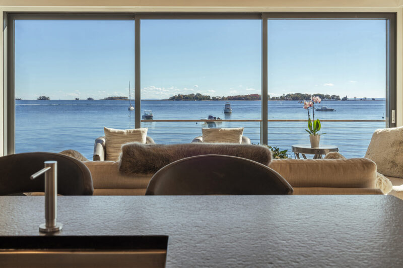 A view of the large living room windows from the kitchen