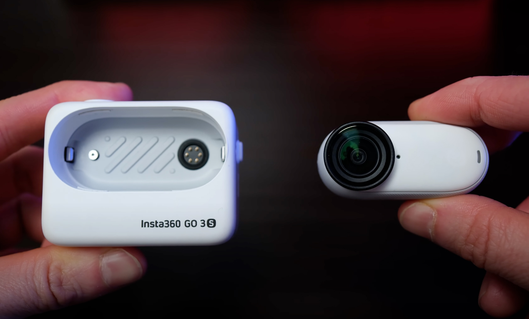 Holding up the Insta360 Go 3S in the separated parts