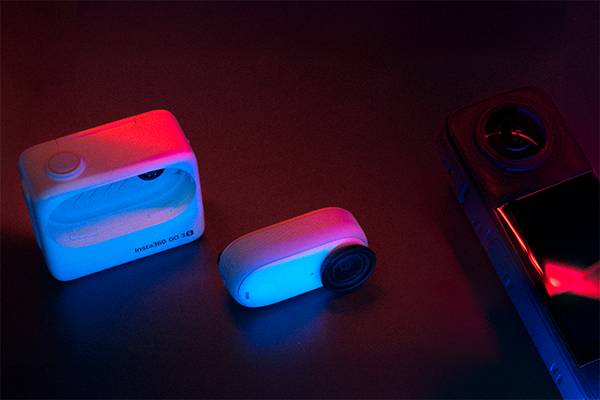 The insta360 Go 3S and X4 lying on a surface with neon lighting