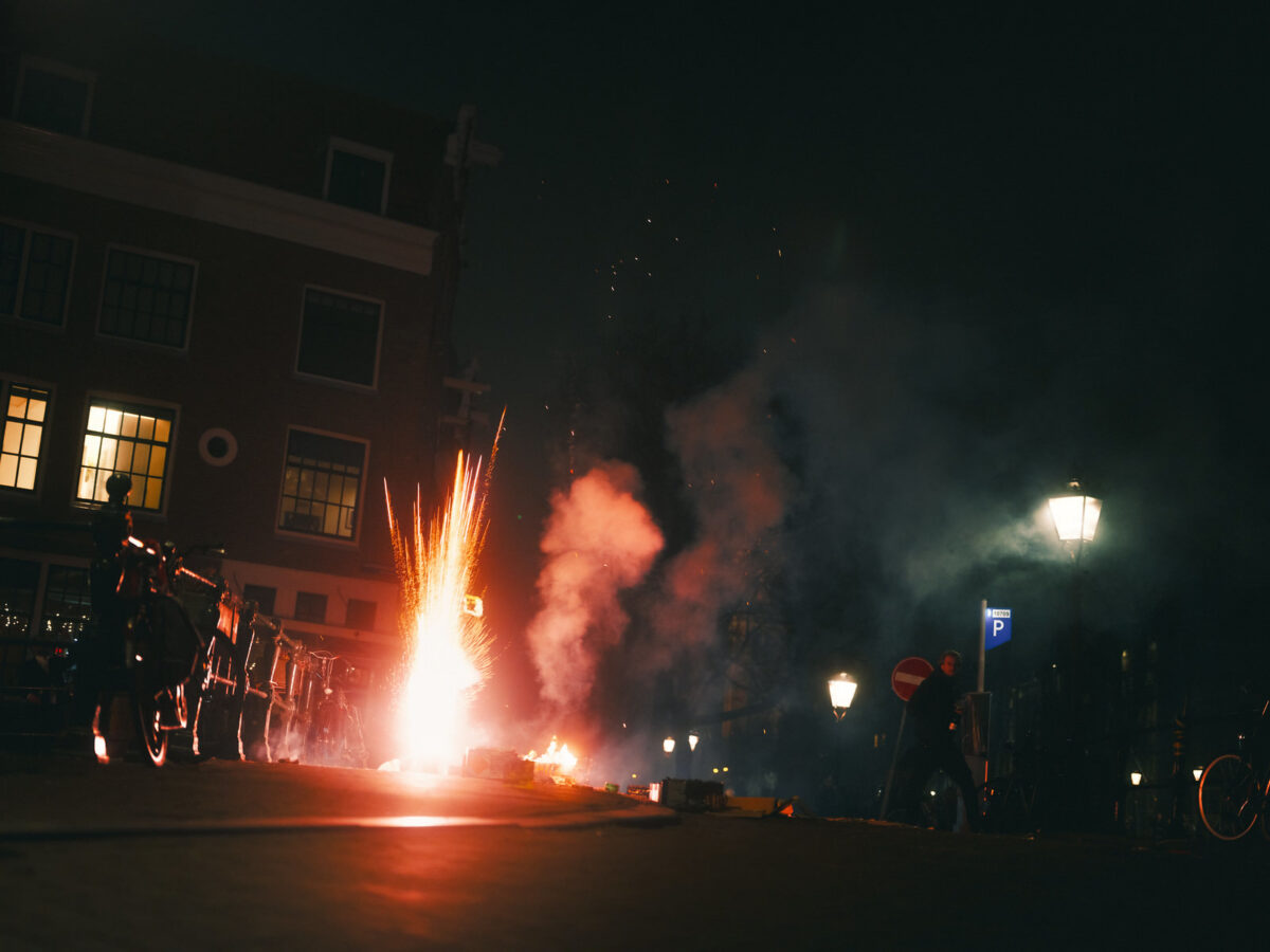 Fireworks launching from ground level with sparks and smoke